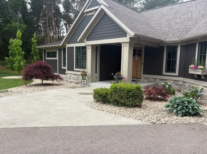 Premium paver patio with natural stone retaining wall at sunset